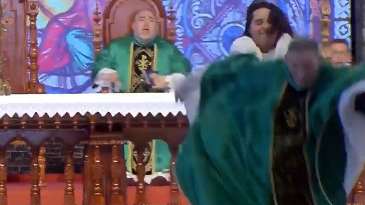 Woman pushes priest accused of homophobia off a stage in Brazil