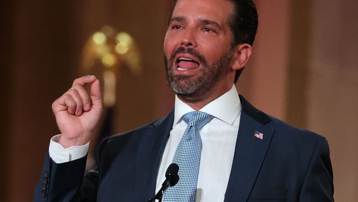 Trump Jr posts shocking video ranting about schools being closed in front of a wall lined with rifles