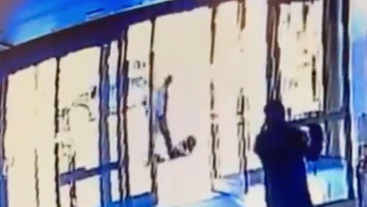 Asian woman violently attacked as security guard watches then shuts the door in her face