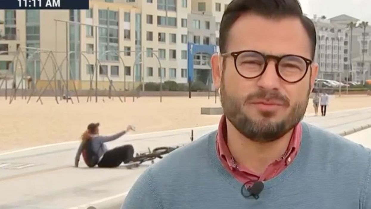 Slapstick moment cyclist crashes while taking selfie during live news broadcast