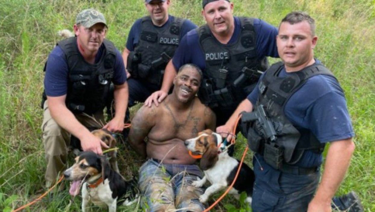 Police under fire for posing with suspect after manhunt