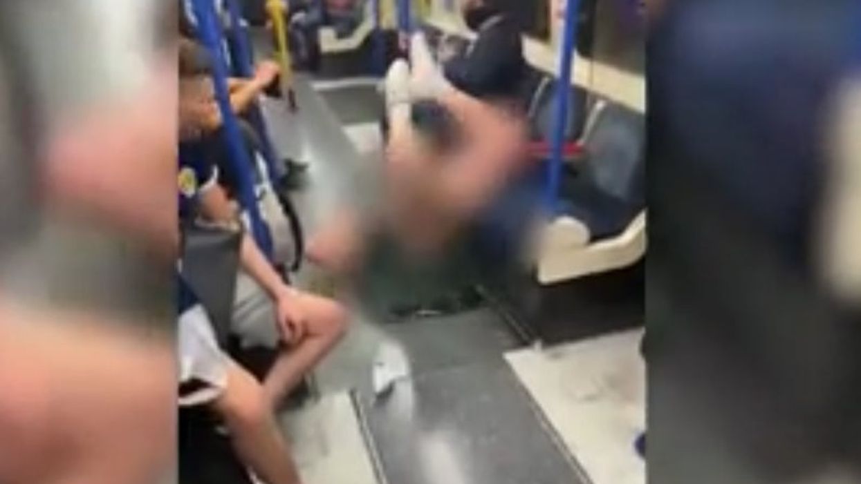 Kilted Scotland fan does the worm on the Tube and leaves little to the imagination