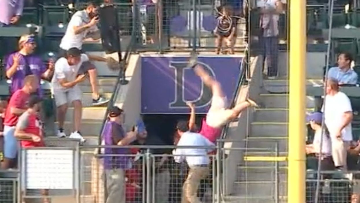 Man filmed doing body flip and clattering to the ground after trying to catch baseball