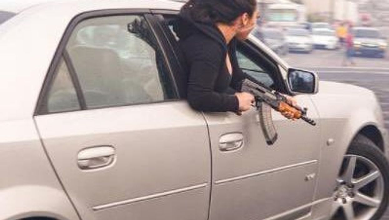 Stunning photo shows woman hanging out of car window wielding AK-47 in San Francisco