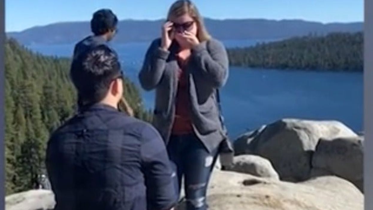 Hikers photobomb couple’s public proposal by walking right into camera shot
