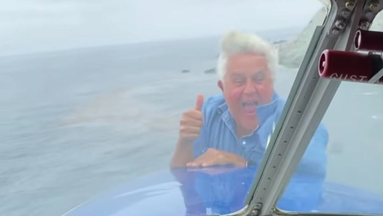Jay Leno performs surprise mid-air stunt, dangles out of flying plane: ‘Just being stupid’