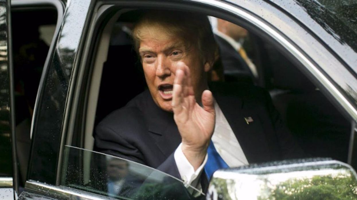Photo of woman furiously flipping off Trump's car on election day goes viral