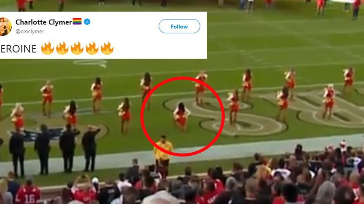 NFL cheerleader takes a knee during American national anthem