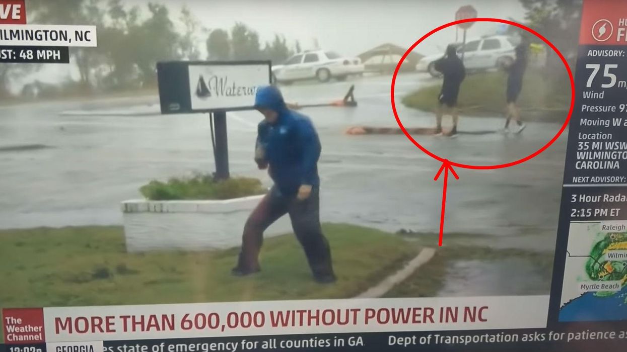Weatherman caught bracing intensely for Hurricane Florence... as two people walk by easily