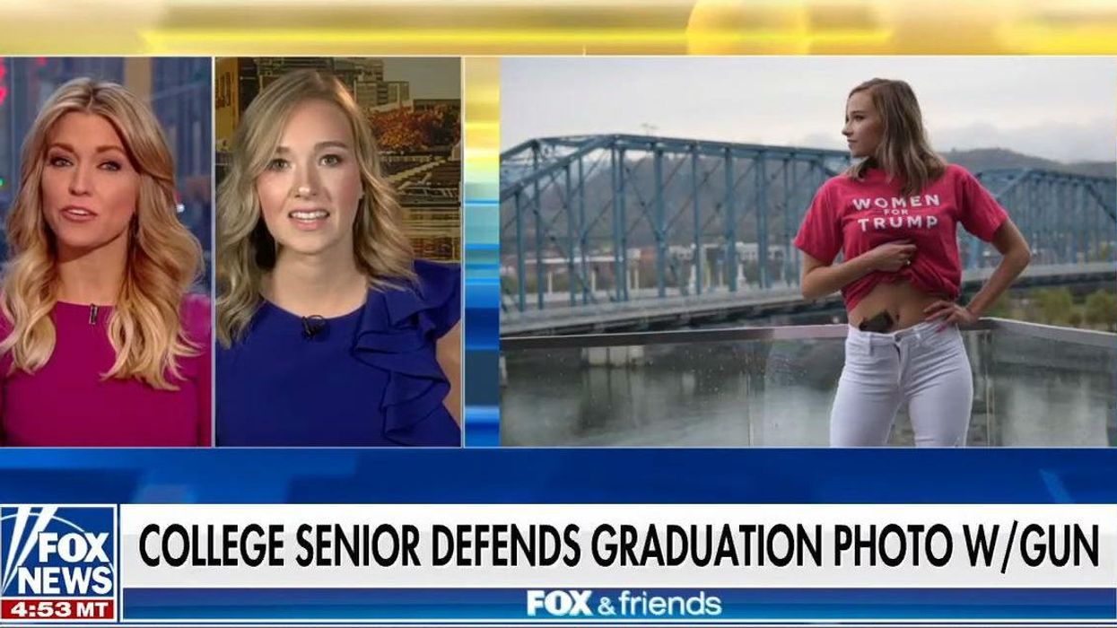 Gun-toting student defends viral graduation photo