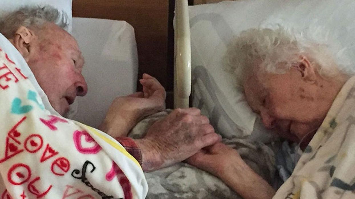 People are heartbroken by this 100-year-old man holding his dying wife's hand after 77 years of marriage