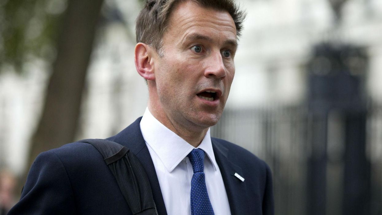 This photo of Jeremy Hunt standing next to a rude road sign is not all it seems