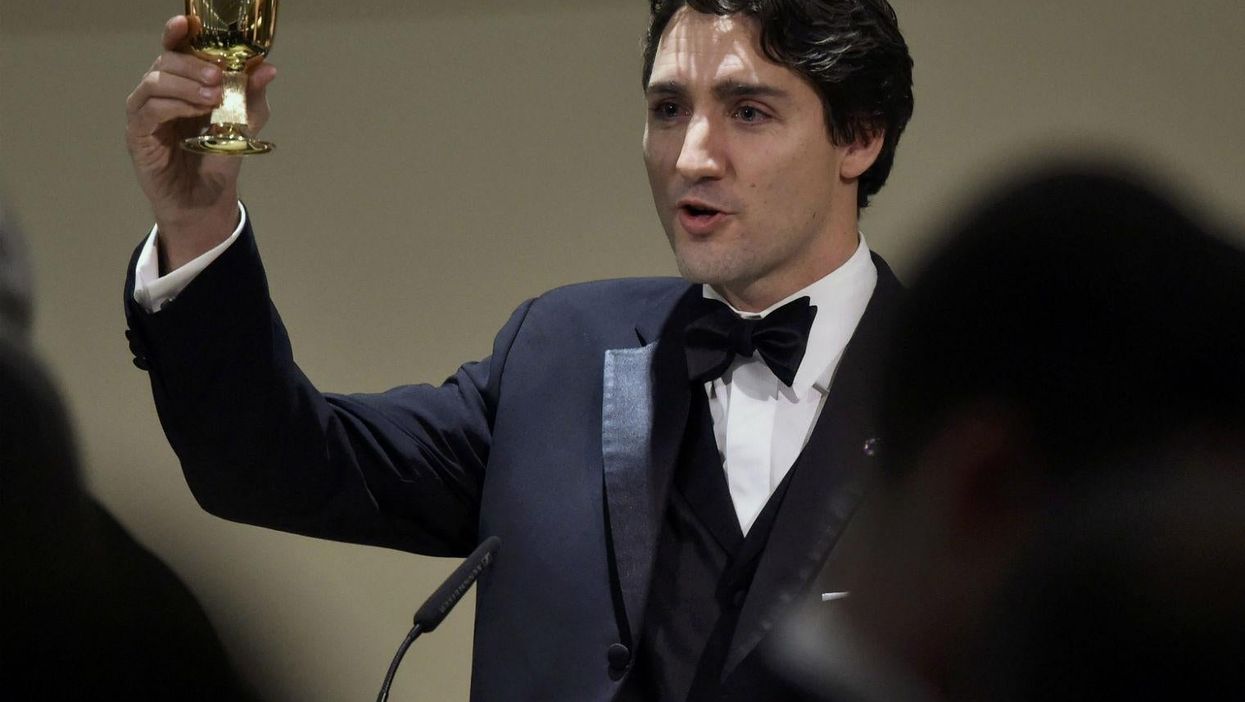 Just Canada's Justin Trudeau cutting his birthday cake like a badass