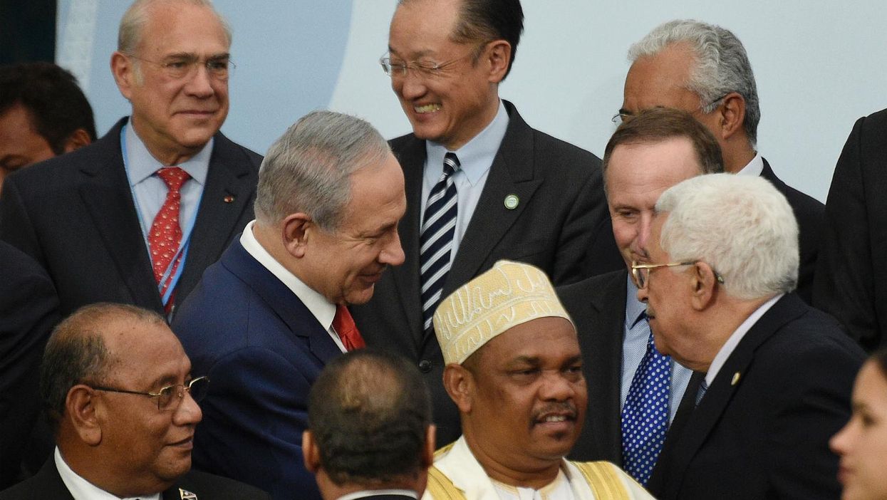 Israeli and Palestinian leaders shake hands for first time in five years. And also get massively photobombed