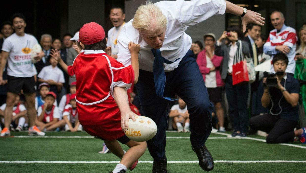 Just Boris Johnson rugby tackling a Japanese 10-year-old