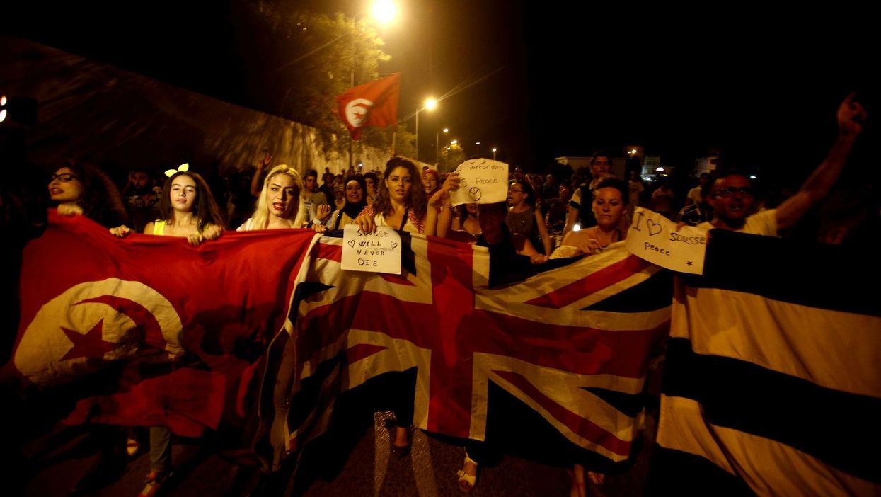 Tunisians with British flags march against terror in candlelight protest