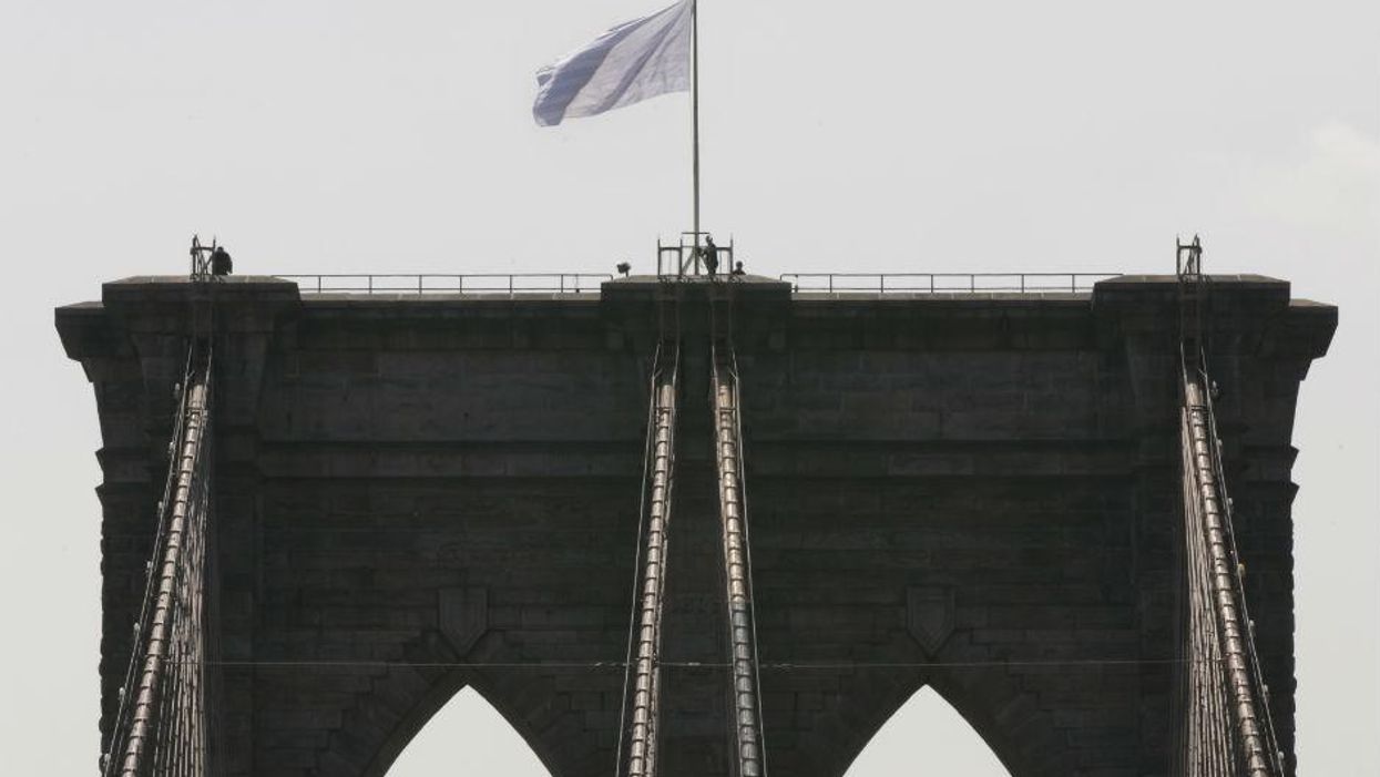 Two white flags placed atop Brooklyn Bridge but no one knows how or why