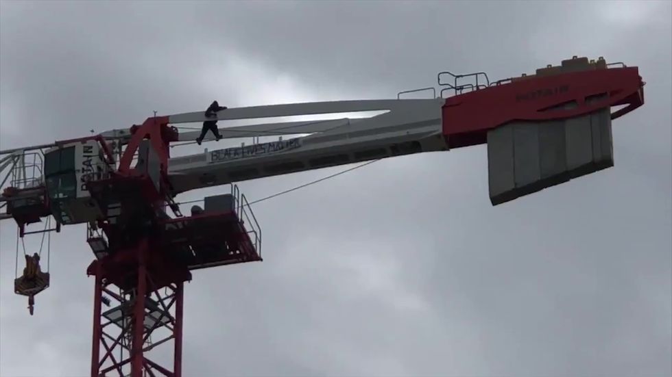 Black Lives Matter flag flown from crane in East London