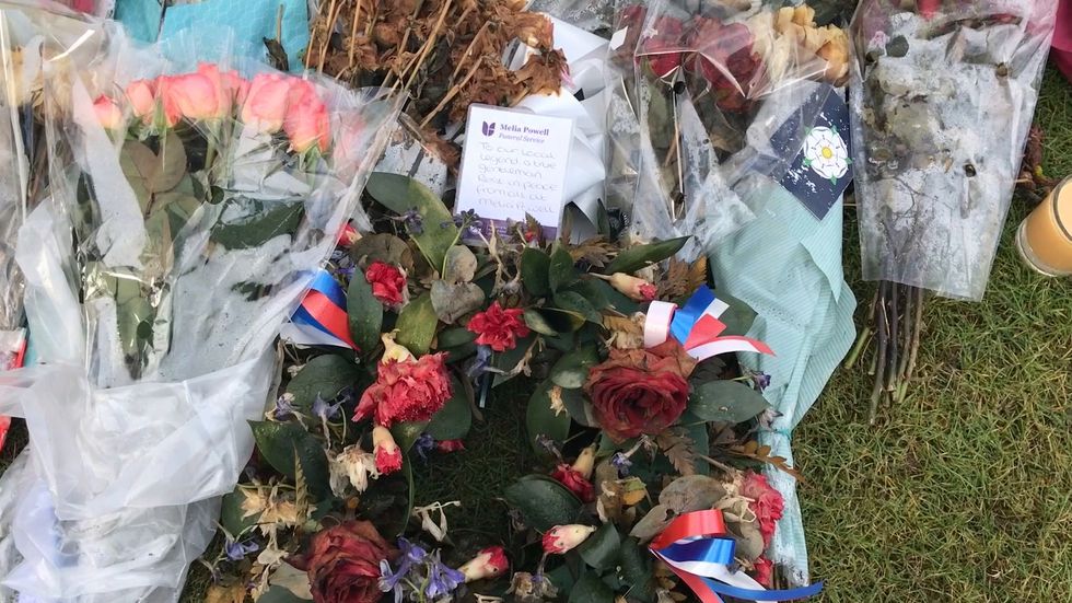 Flowers left on Captain Sir Tom plaque in Keighley, West Yorkshire