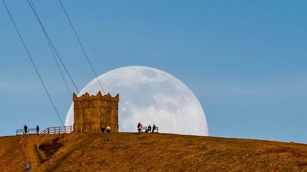 Stunning moment huge snow moon rises in Bolton