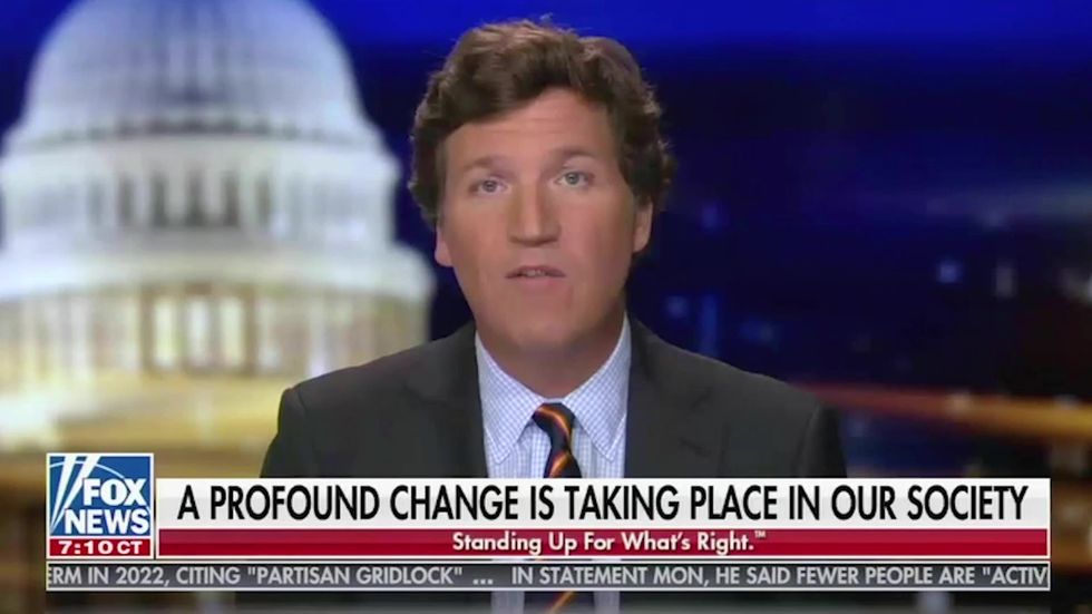 Fox News host Tucker Carlson defends QAnon