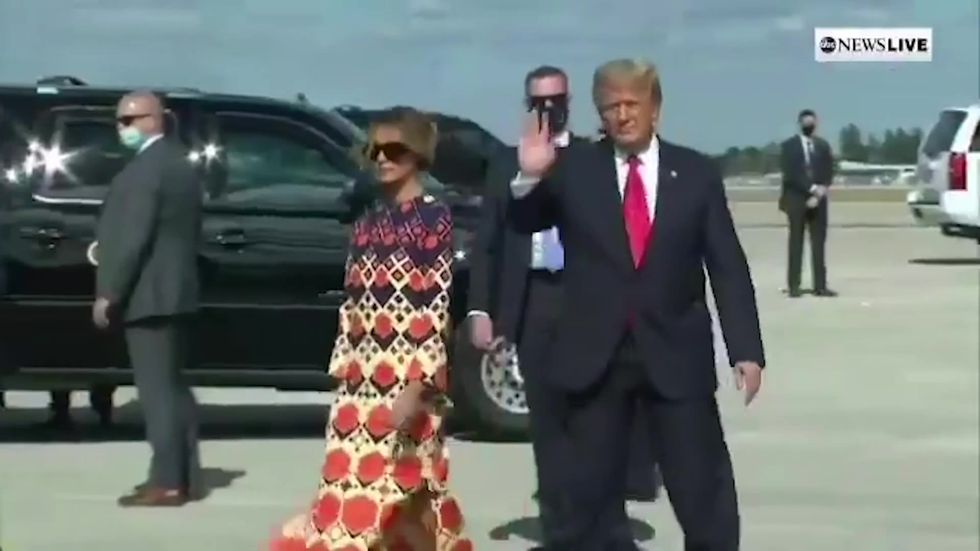 Melania walks away from Trump as they arrive in Florida
