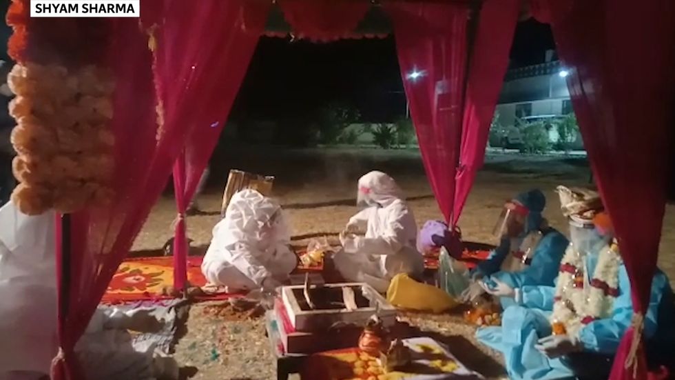 Indian couple marry in hazmat suits after bride tests positive for Covid on wedding day