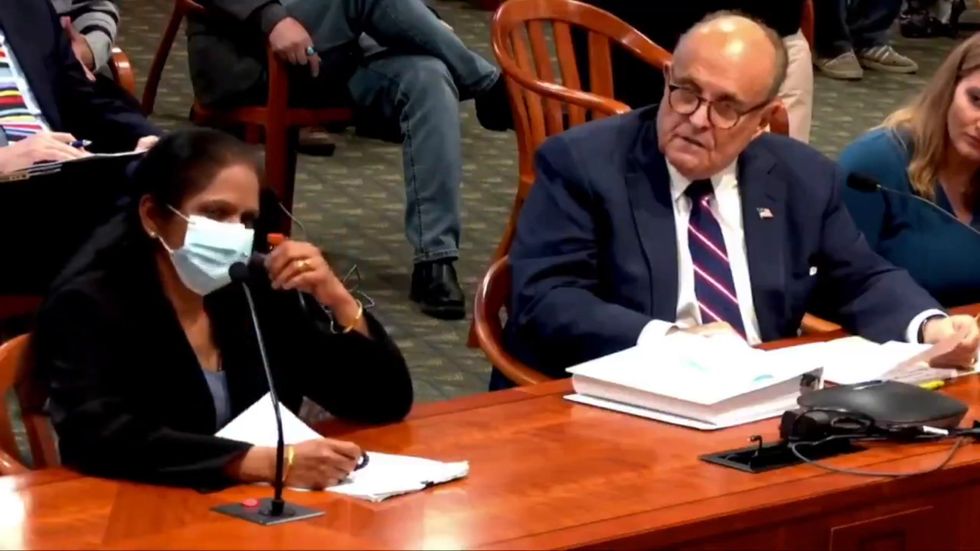 Rudy Giuliani asks a woman at a Michigan hearing to remove her mask