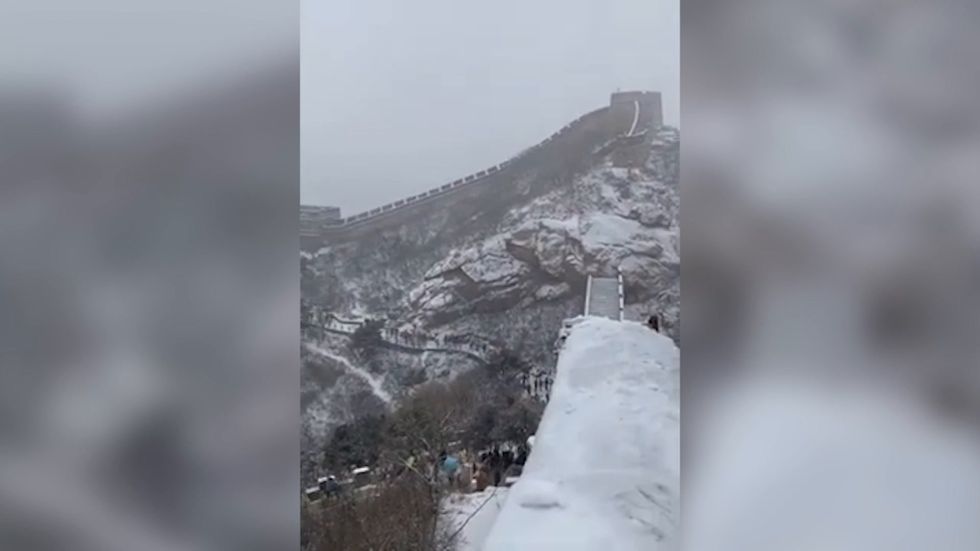Tourist slides down Great Wall of China following heavy snowfall