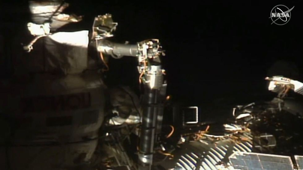 Russian astronauts carry out a spacewalk at the International Space Station