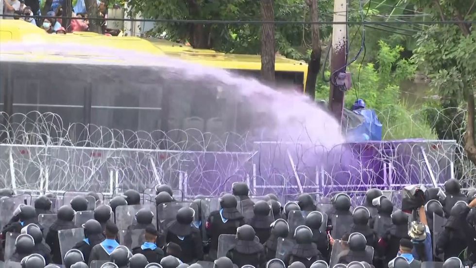 Water cannons met with giant inflatable ducks at Bangkok protest