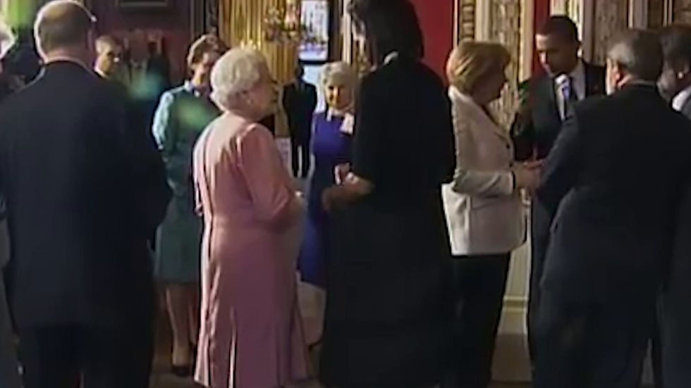 Michelle Obama puts her arm around the Queen during royal visit