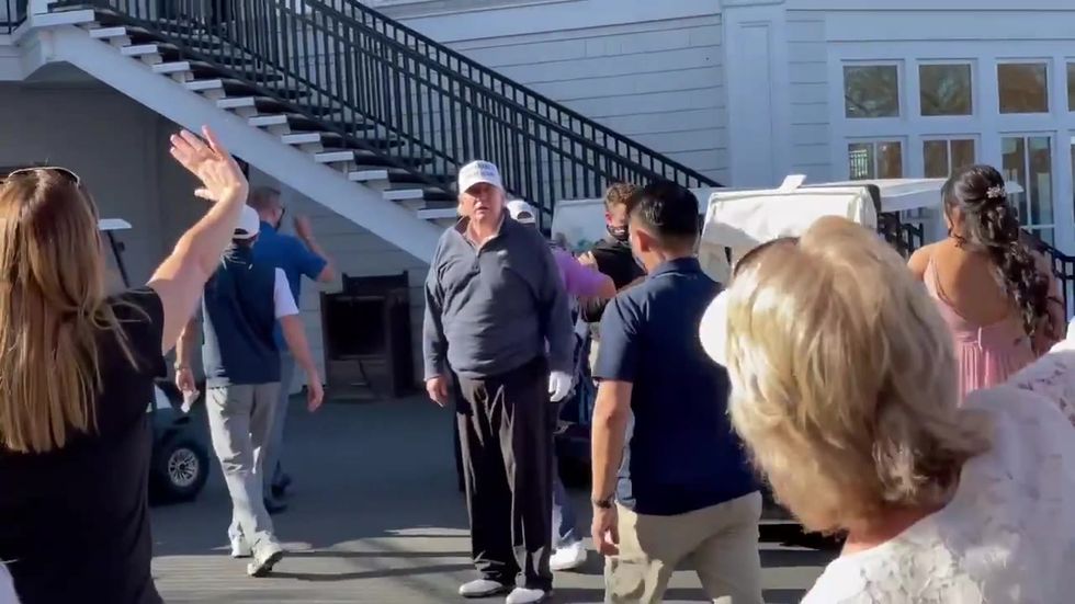 Trump poses with bride after playing golf and losing election
