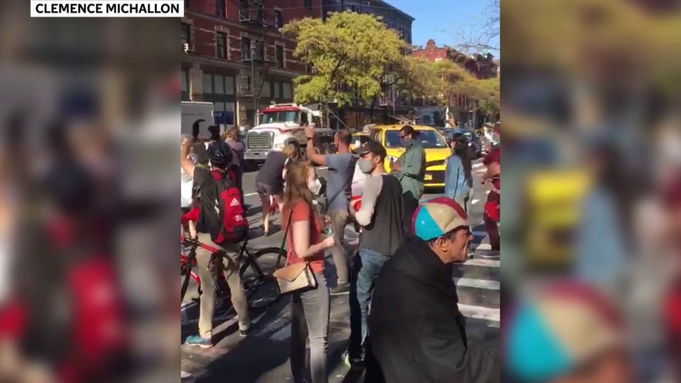 Crowds cheer USPS truck after Joe Biden election victory