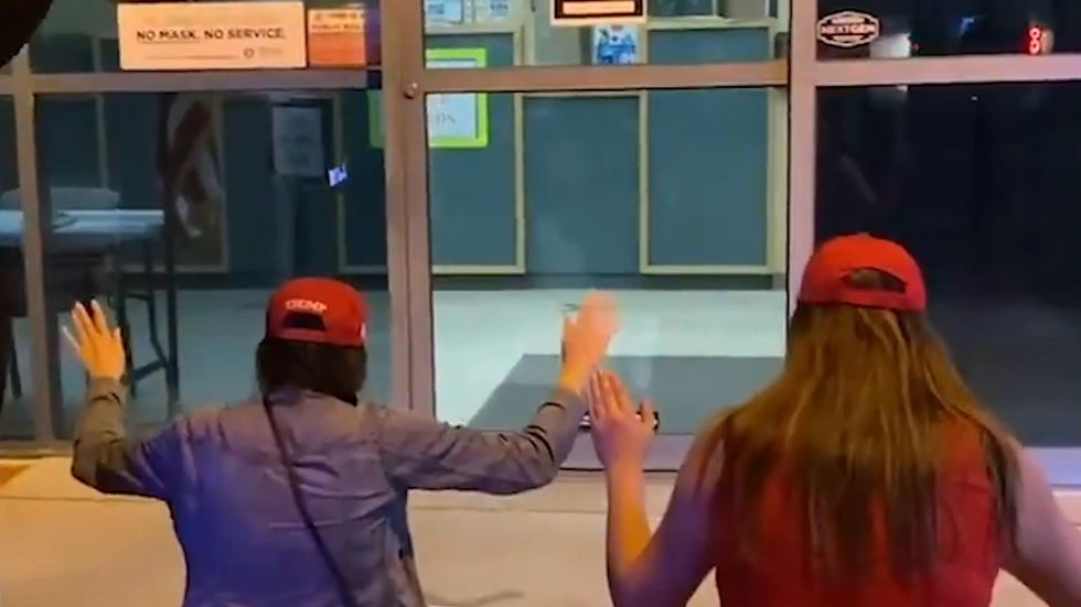 Trump supporters kneel in prayer outside Election Department in Nevada