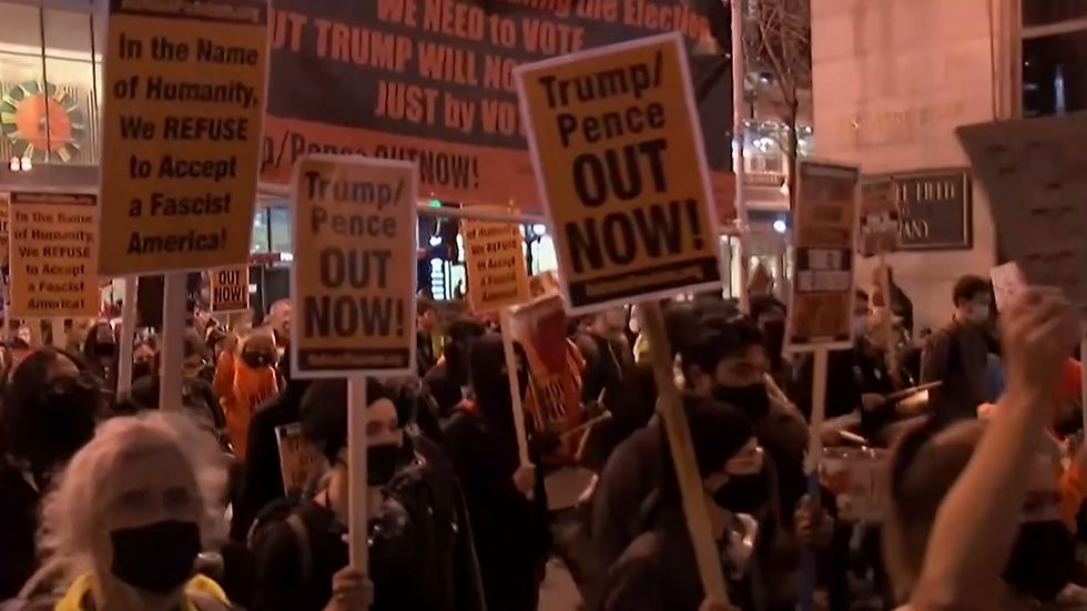 Protests erupt in cities and demonstrators storm voting halls as US waits for election results