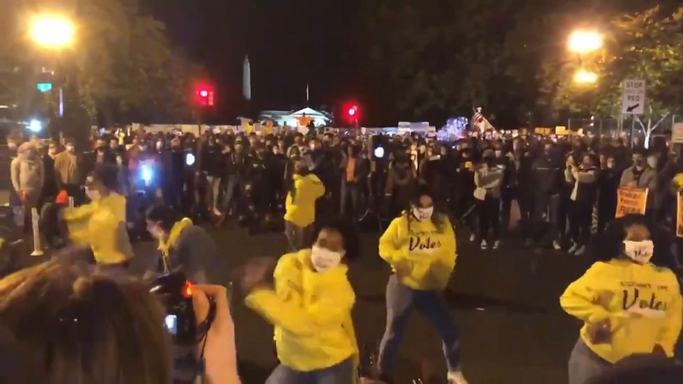 Demonstrators sing and dance at the Black Lives Matter Plaza near the White House