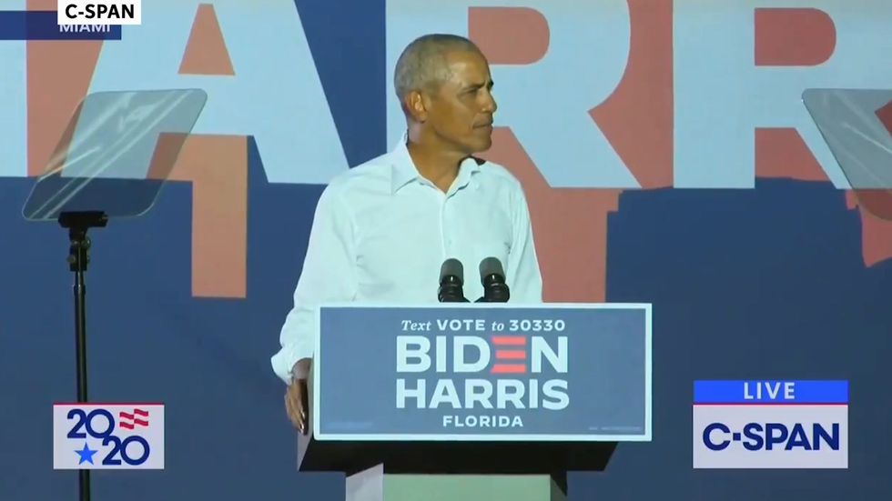 Obama hits out at 'super spreader' Trump at election day eve rally