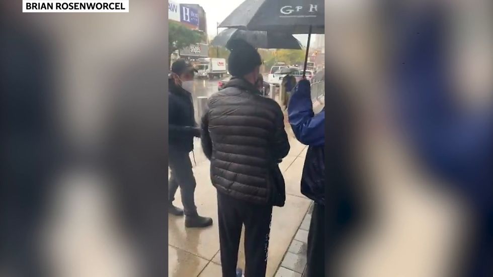 Paul Rudd hands out cookies to Brooklyn voters in the rain