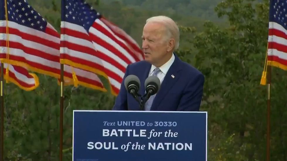 Biden accuses the Trump administration of raising the 'white flag' on the coronavirus pandemic