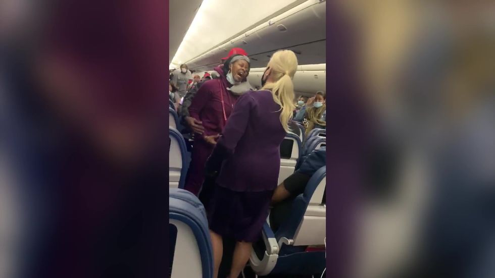 Woman punches Delta flight attendant