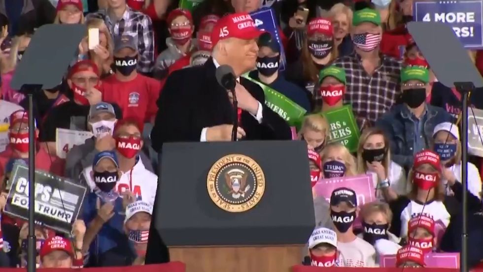 Trump removes his tie in front of screaming fans at Iowa rally