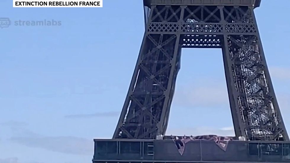 Extinction Rebellion activists scale Eiffel Tower