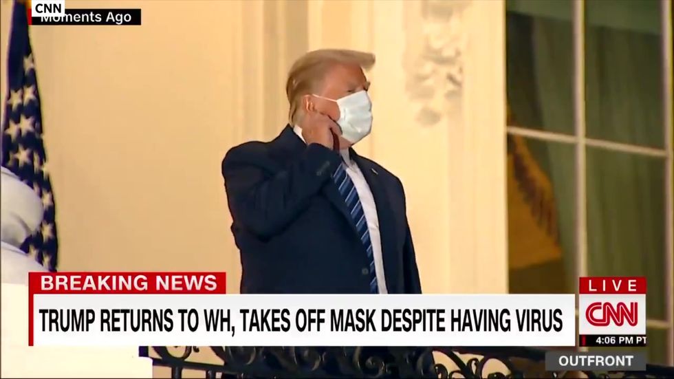 Trump rips off mask after arriving back at White House