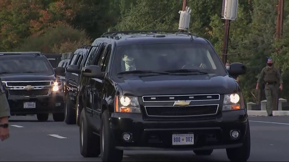 Donald Trump leaves hospital to drive past supporters during coronavirus treatment