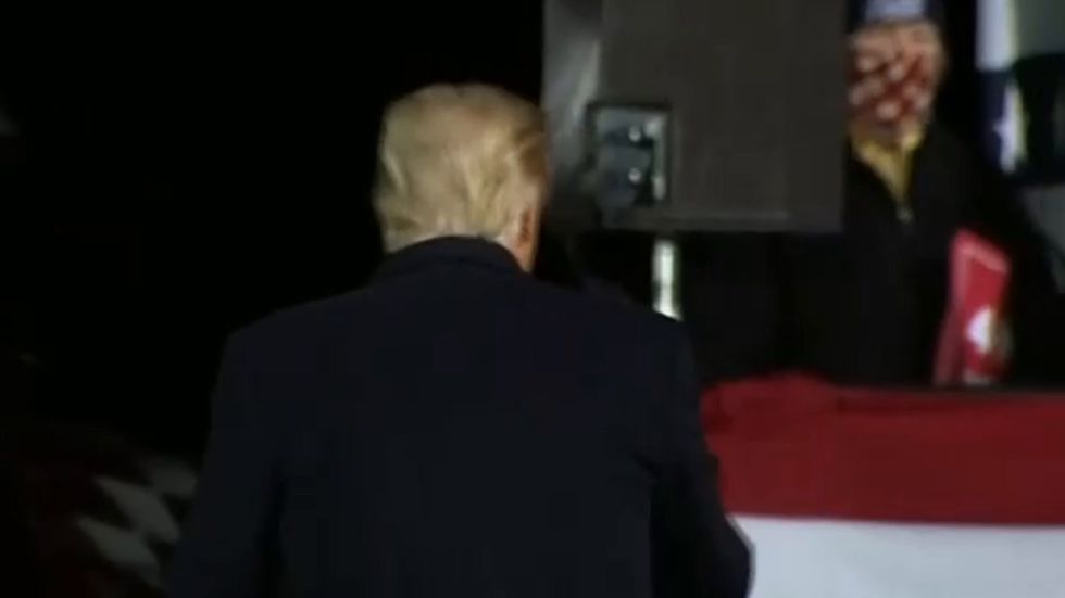 Trump throws hat into Minnesota crowd one day before testing positive for coronavirus