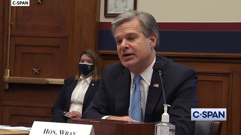 FBI director Christopher Wray warns of Russian efforts to denigrate Joe Biden