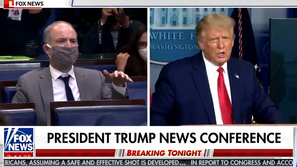 Trump insists that Dr Robert Redfield 'misunderstood the question' as the vaccine is going to be 'very powerful'