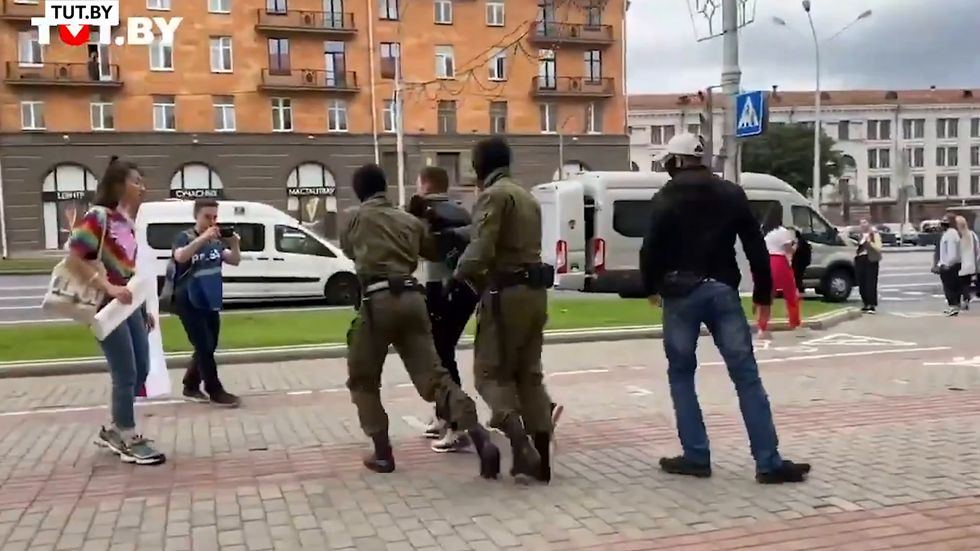Masked men detain student protesters in Belarus