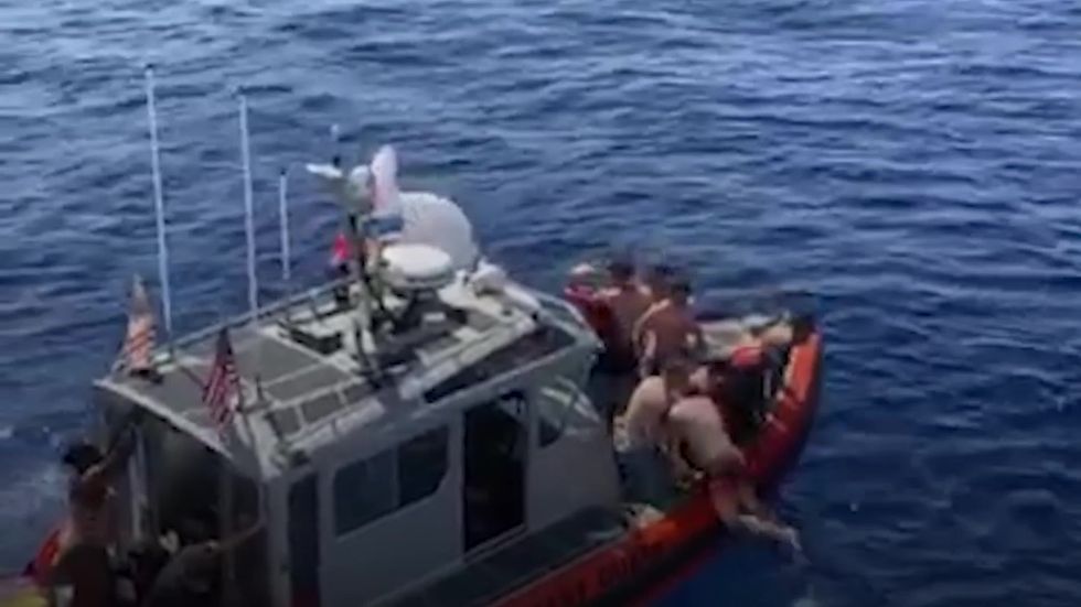 US Coast Guard shoots at eight-foot-long shark in ocean to protect crew members